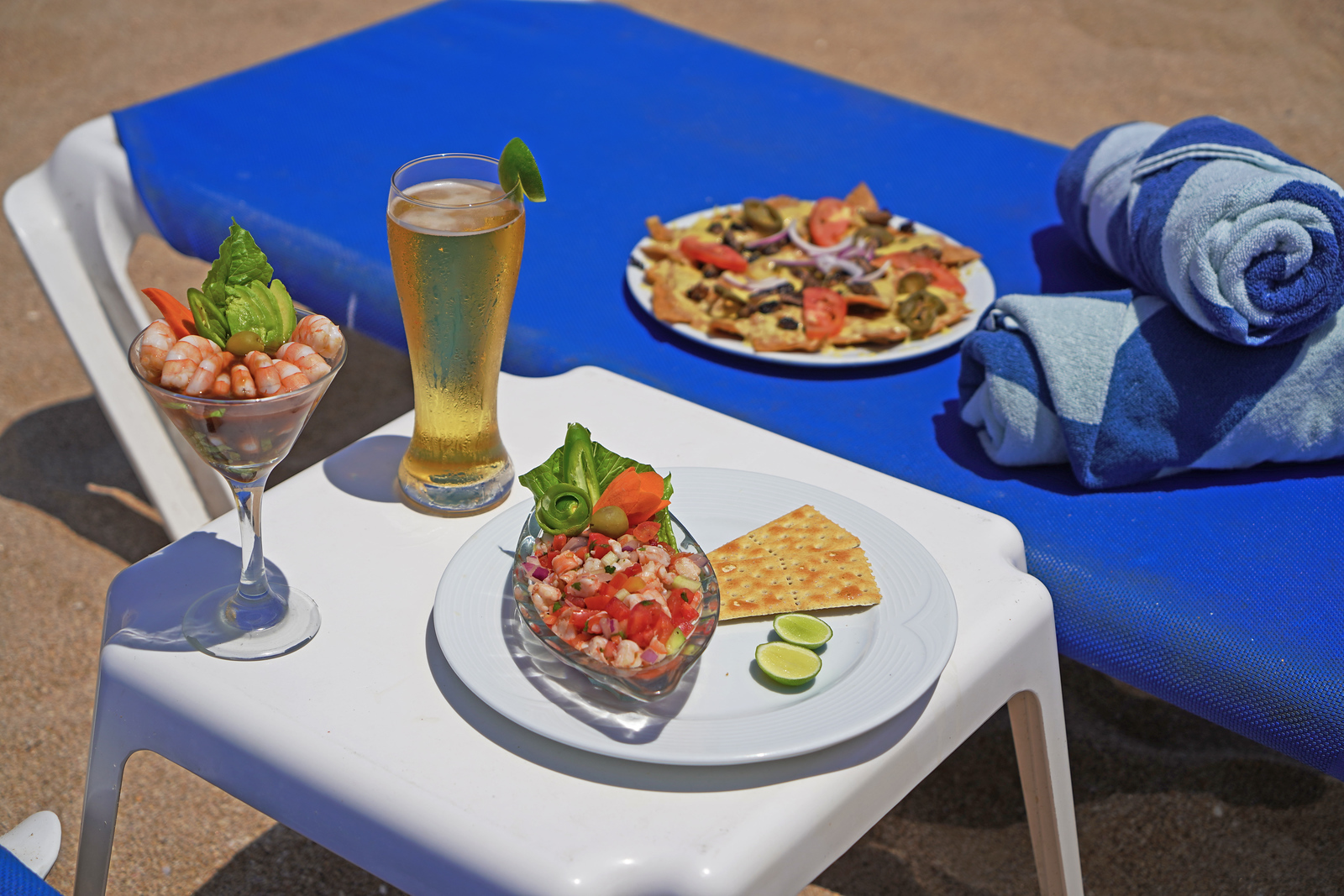 A table of food and drinks on the beach